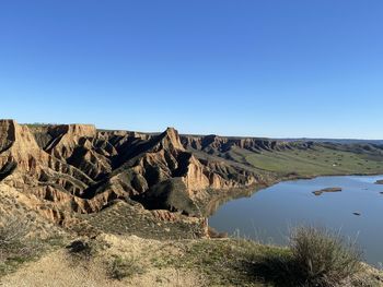 Scenic view of rock formations against clear blue sky
