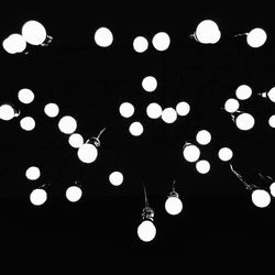 Low angle view of illuminated lanterns hanging from ceiling