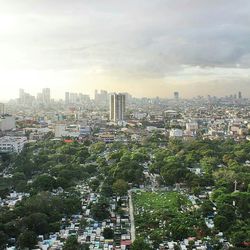 Cityscape against cloudy sky