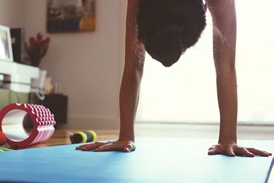 Woman practicing handstand on exercise mat