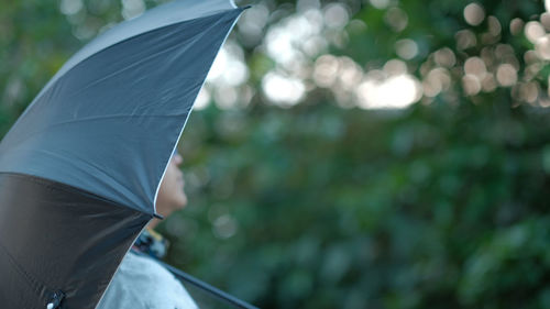 Girl with black umbrella in rainy season.