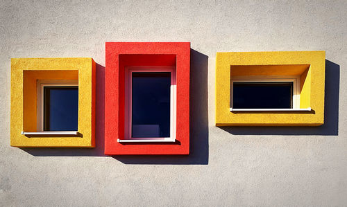 Low angle view of yellow wall with windows