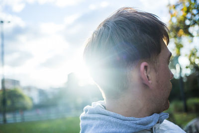 Close-up portrait of teenage girl looking away outdoors