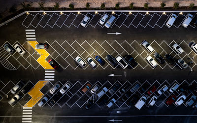 High angle view of arrow sign on parking lot