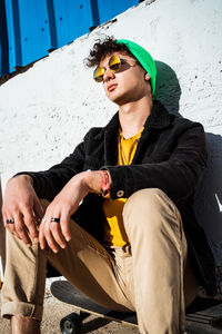 Young man sitting on seat