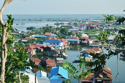 High angle view of townscape by sea against sky