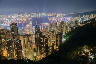 High angle view of illuminated buildings in city at night