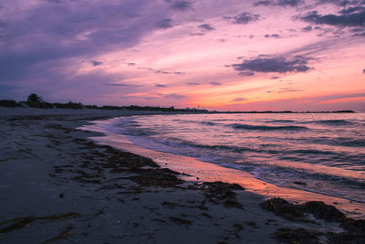 Scenic view of beach against sky during sunset