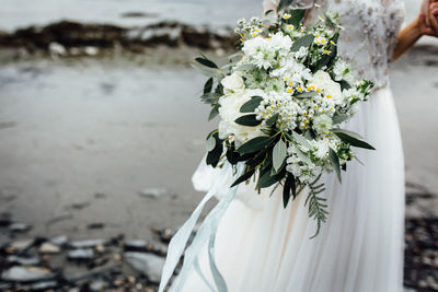 Close-up of bride with bouquet