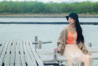 Young woman standing at sea shore