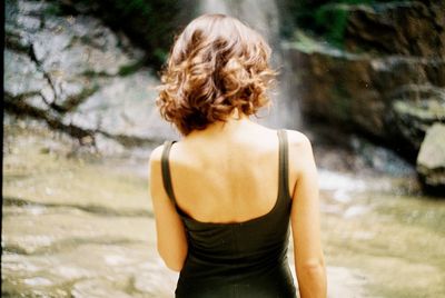 Rear view of woman standing outdoors