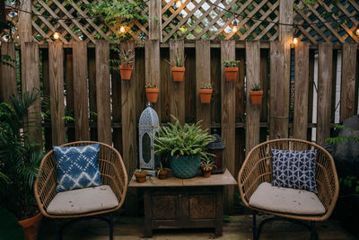 Empty chairs and table in yard