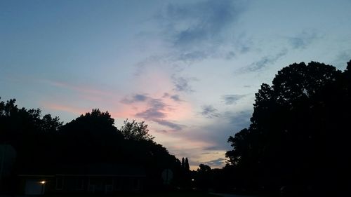 Low angle view of silhouette trees against sky at sunset