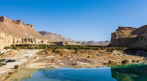 Panoramic view of rocks and mountains against clear blue sky