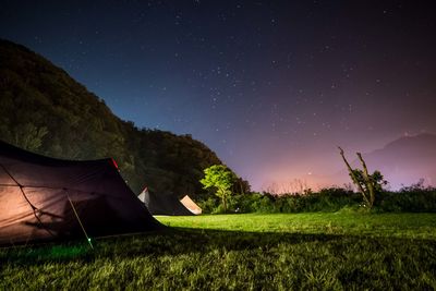 Scenic view of field against sky at night