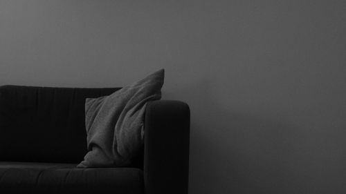 Cushion on sofa against wall at home