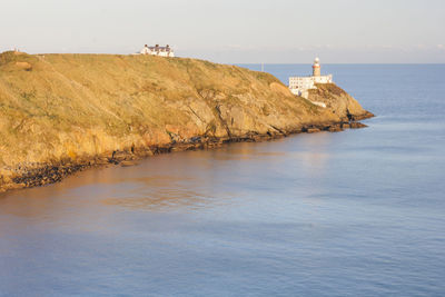 Scenic view of sea and buildings against sky