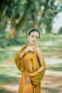 Portrait of young woman standing outdoors