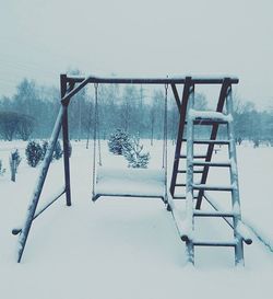 Snow covered trees on field