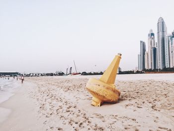 Deck chairs on beach against clear sky