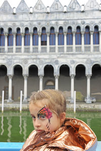 Portrait of girl in front of building