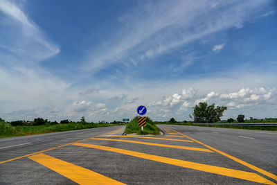 Zebra crossing on road against sky