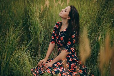 Woman sitting in field