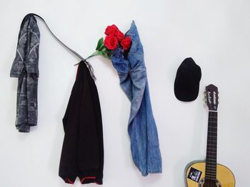 Clothes drying on wall against white background
