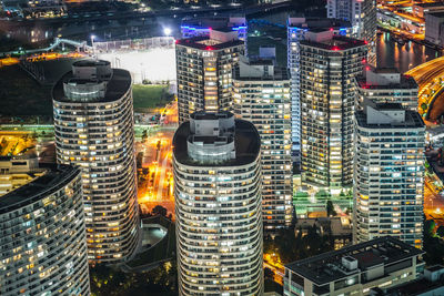 High angle view of illuminated buildings in city at night