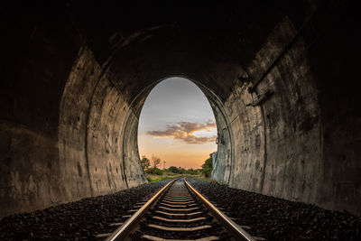 Rear view of man walking in tunnel