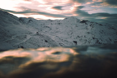 Scenic view of snowcapped mountains against sky during sunset