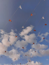 Low angle view of kites flying in sky