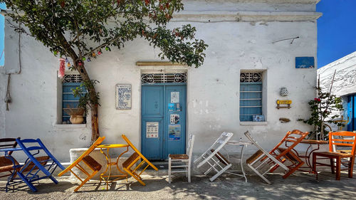 Empty chairs and tables of a traditional coffee shop at cyclades islands, greece
