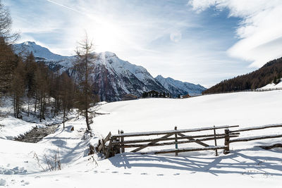 Scenic view of snow covered mountains against sky