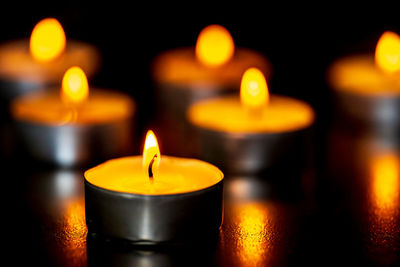 Close-up of lit candles in temple