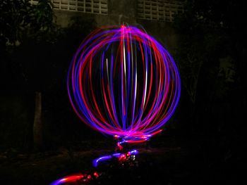 Light painting against trees at night