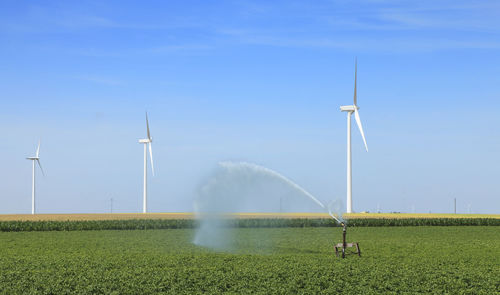 Windmill on field against sky