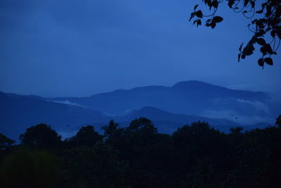 Scenic view of silhouette mountains against sky at dusk