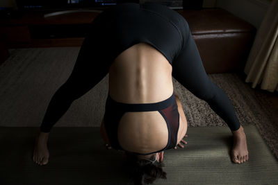 Young woman exercising at home