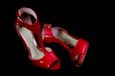 Close-up of red shoes over black background