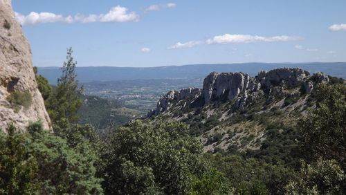 Scenic view of mountains against cloudy sky