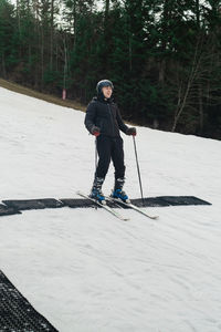 Man skiing on snow covered field