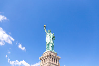 Low angle view of statue against blue sky
