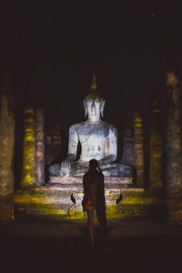 Rear view of statue against temple building