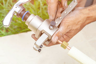 Close-up of man working on metal