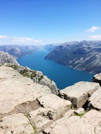 Scenic view of mountains against blue sky