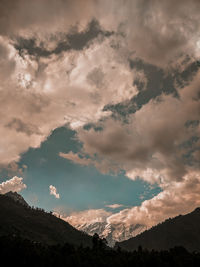 Low angle view of silhouette mountain against sky