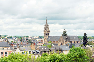 Buildings in town against sky