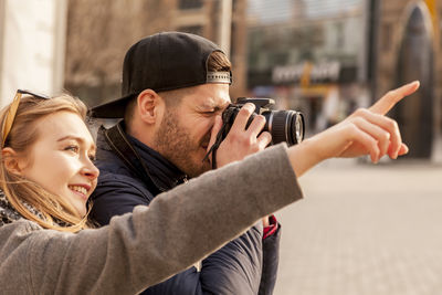 Young couple photographing with camera