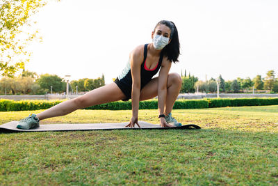 Full length of woman sitting on grass